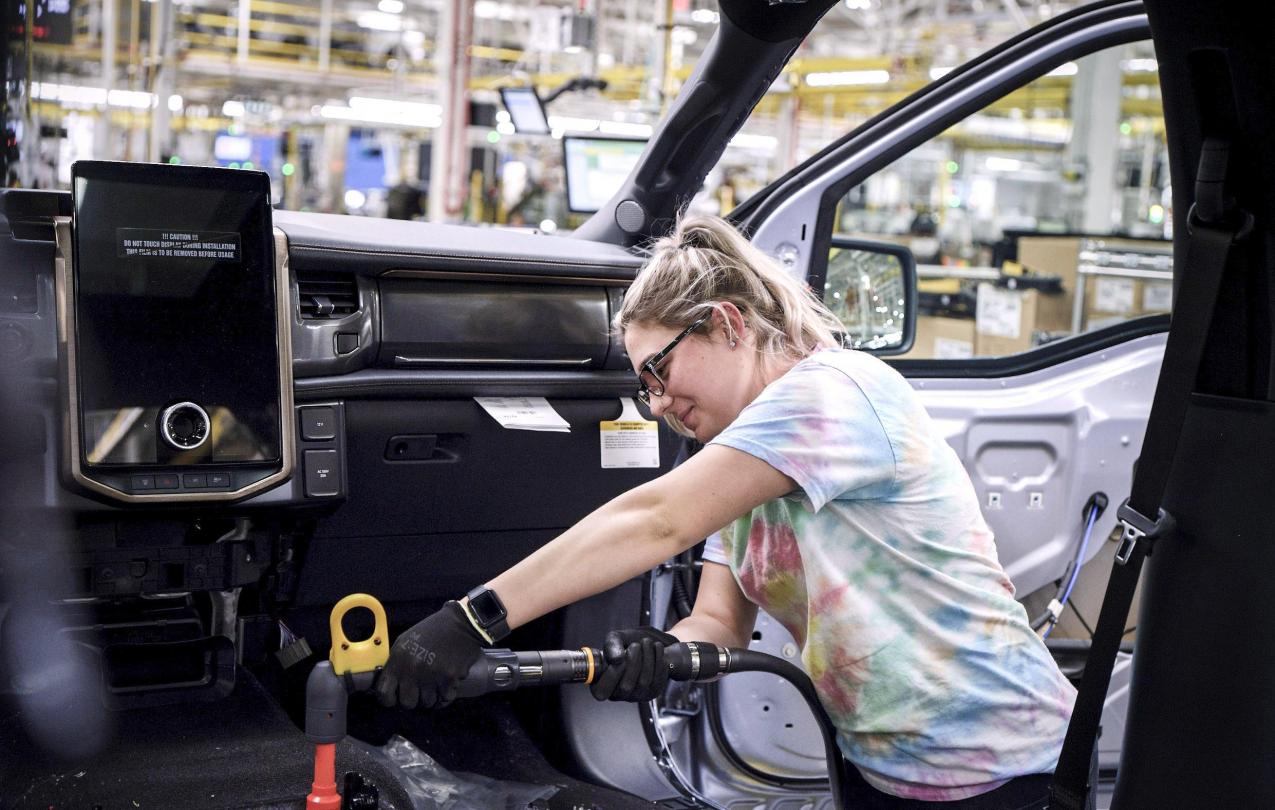 Electric Vehicle Workers building a car