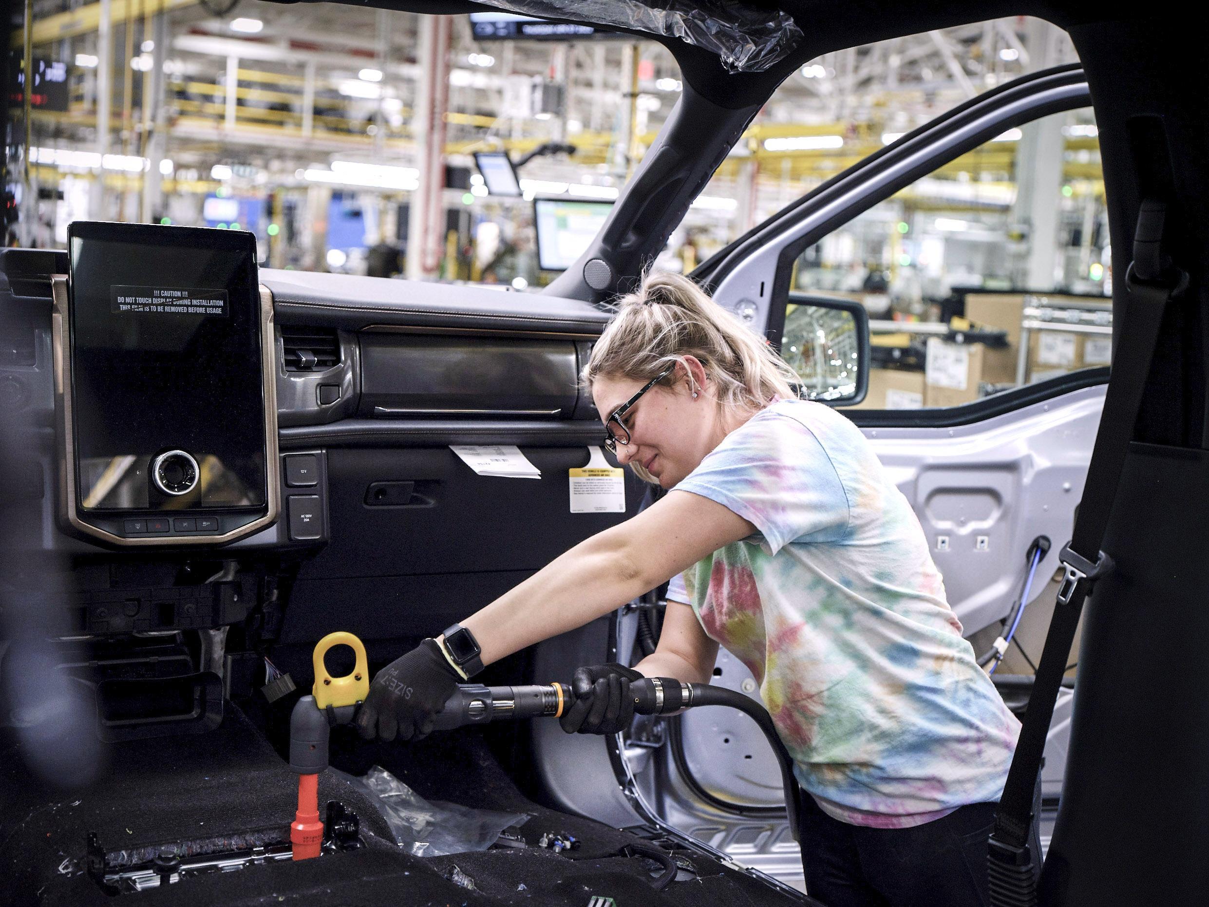 Electric Vehicle Workers building a car